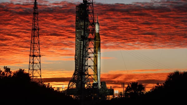 NASA's SLS rocket and Artemis 2 Orion spacecraft at sunrise